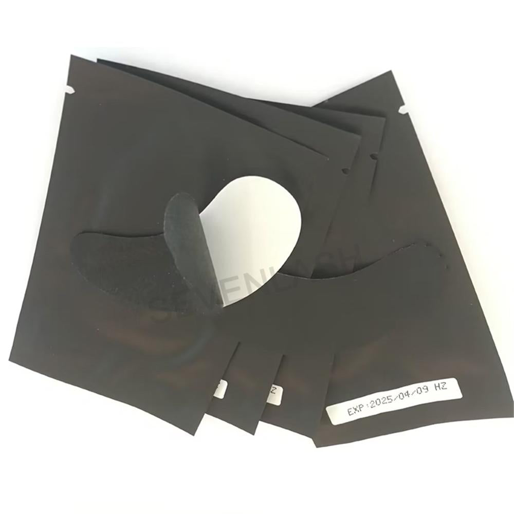 Texture close-up of black lint-free eye pad showing smooth surface and tear line