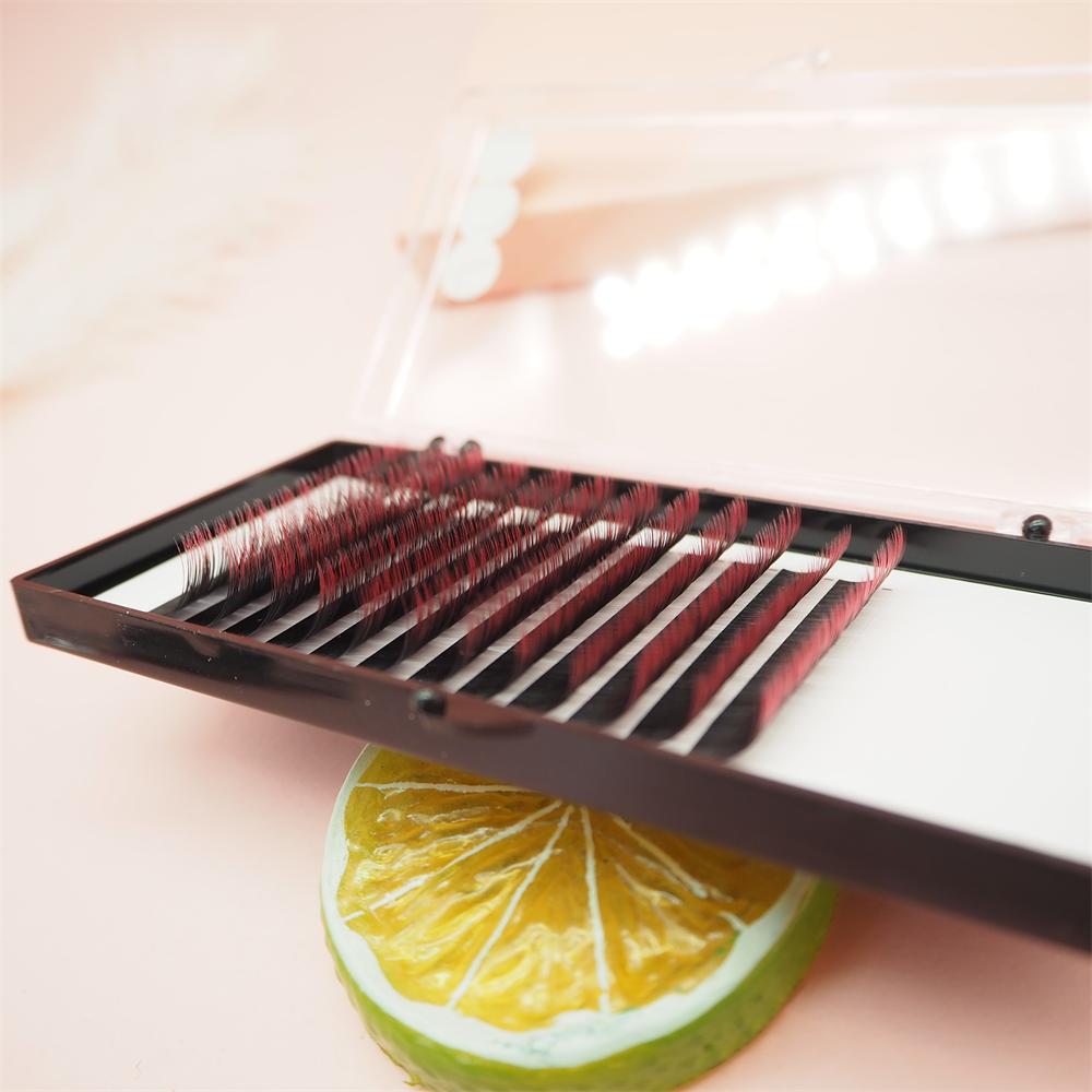 Technician creating fans with colorful ombré lashes for volume set